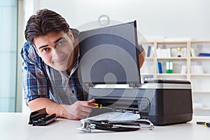 The repairman repairing broken color printer