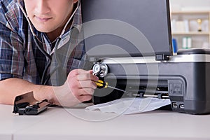 The repairman repairing broken color printer