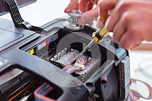 The repairman repairing broken color printer