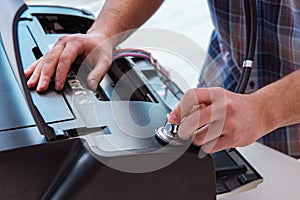 The repairman repairing broken color printer