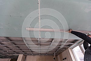 Repairman Repairing Ceiling, Ceiling panels broken and damage from water leakage ,Home maintenance and repair home