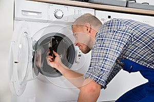 Repairman Repairing Washer