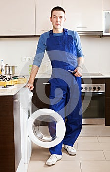 Repairman repairing washing machine