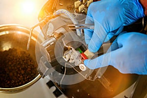 A repairman repairs a broken coffee maker