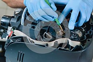 A repairman repairs a broken coffee maker