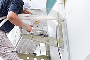 Repairman service for repair and maintenance of air conditioners, Technician team install new air conditioner