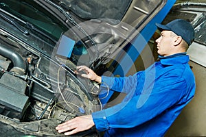 Repairman servicing auto car