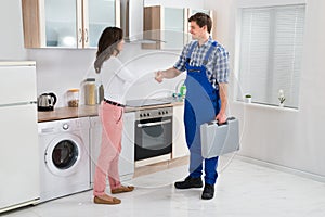 Repairman Shaking Hands With Woman