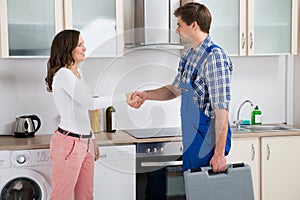 Repairman Shaking Hands With Woman