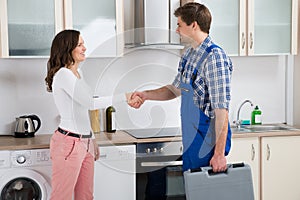 Repairman Shaking Hands With Woman photo