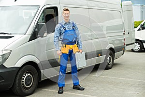 Repairman With Tools And Toolbox In Front Of Van