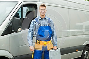 Repairman With Tools And Toolbox In Front Of Van
