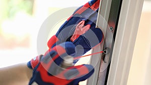 Repairman using lubricate for fix up problem with lock of plastic window.