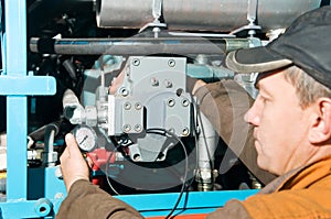 Repairman using manometer