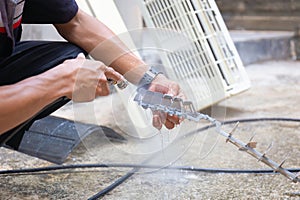 Repairman washed the dirty air conditioner filter, Technician cleaned mold in the air conditioning system, Maintenance and service