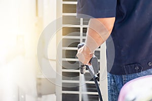 Repairman washing dirty compartments air conditioner, Male technician cleaning air conditioner indoors, Maintenance and repairing