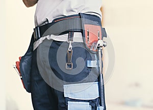 Repairman wearing a tool belt close up