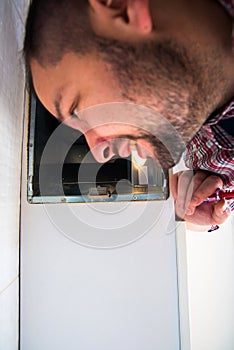 Repairman work on ventilation in the kitchen