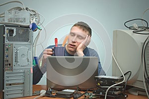 Repairman working on laptop computer.