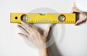 Repairman working with measuring ruller on the wall