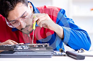 Repairman working in technical support fixing computer laptop tr