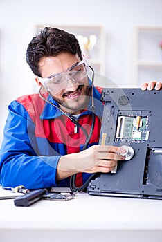 Repairman working in technical support fixing computer laptop tr