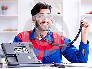 Repairman working in technical support fixing computer laptop tr