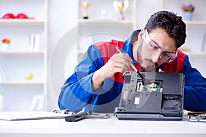 Repairman working in technical support fixing computer laptop tr