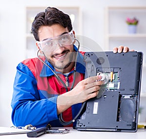 Repairman working in technical support fixing computer laptop tr