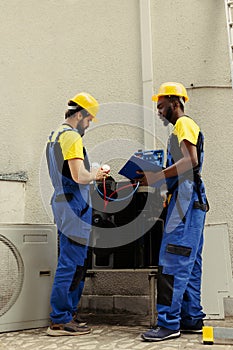 Repairmen enlisted to do condenser check photo