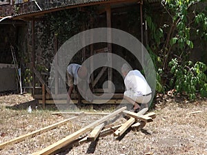 Repairs being made on a dog pen in the tropics
