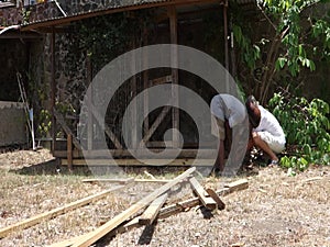 Repairs being made on a dog pen in the tropics