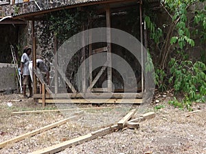 Repairs being made on a dog pen in the tropics