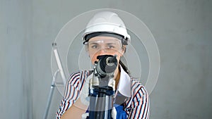 Repairwoman with a Puncher Doing Home Renovation