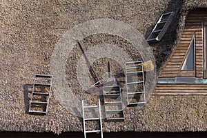 Reparing a thatched roof ladders