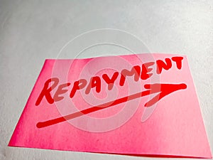 repayment banking word displayed on pink paper slip