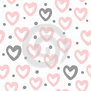 Repeated round dots and hearts drawn by hand with a rough brush. Cute watercolour seamless pattern.