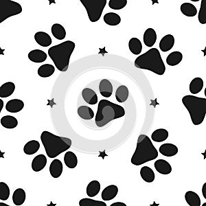 Repeated silhouettes of paw prints and stars. Seamless pattern for animals.