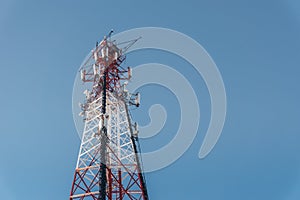 Repeater tele communication tower with blue sky on background. Cell phone tower