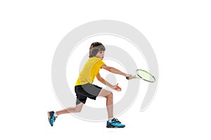 Dynamic portrait of teen, sportive kid playing tennis isolated over white studio background. Concept of sport
