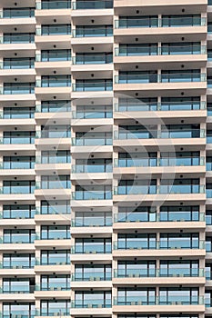 Repeating pattern of windows and balcony. Bulding front
