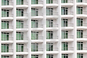 Repeating pattern of windows and balcony. Bulding front