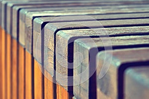 Repeating texture of wooden bars. Modern architecture bench in the city park