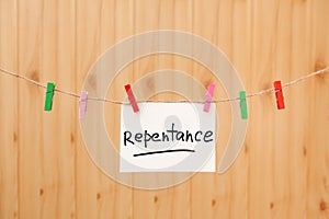 Repentance - christian card with text and clothespins on rope with wooden background, religion concept