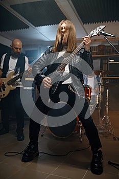 Repetition of rock music band with handsome bass guitarist playing music