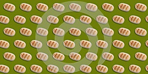 Repetitive pattern of a marzipan on a green background. unhealthy diet. excess sugar
