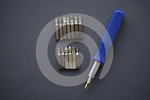 Replaceable nozzles for a screwdriver. Blue screwdriver with attachments