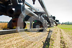 Replaceable sprayer of a field high-clearance sprayer on a hinged boom