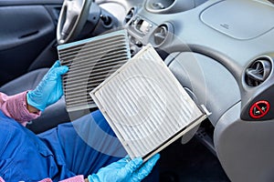 Replacement of cabin pollen air filter for a car. Basic auto mechanic skills concept.