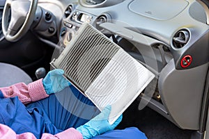 Replacement of cabin pollen air filter for a car. Basic auto mechanic skills concept.